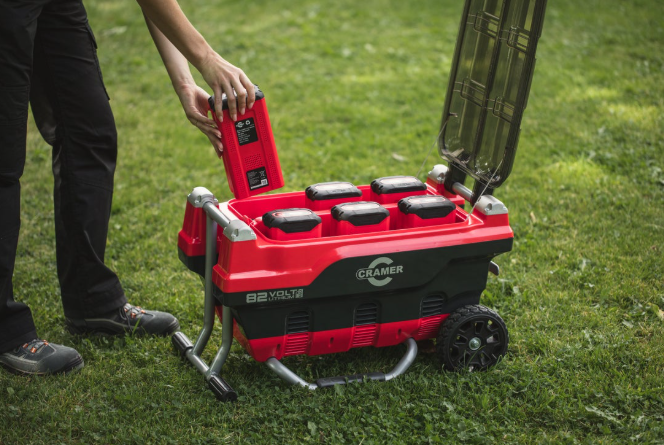 Red and Black Cramer 82V Professional 6 Slot Rapid Charging Station in use