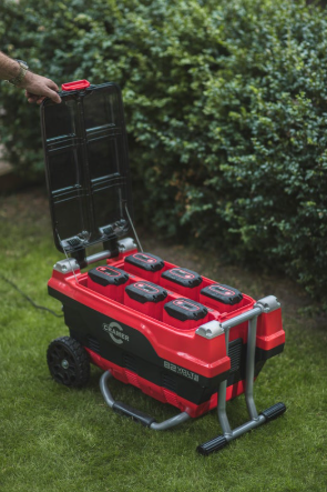 Red and Black Cramer 82V Professional 6 Slot Rapid Charging Station in use