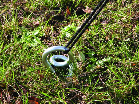 Green Powder coated Ground anchor by RiggFix in the ground